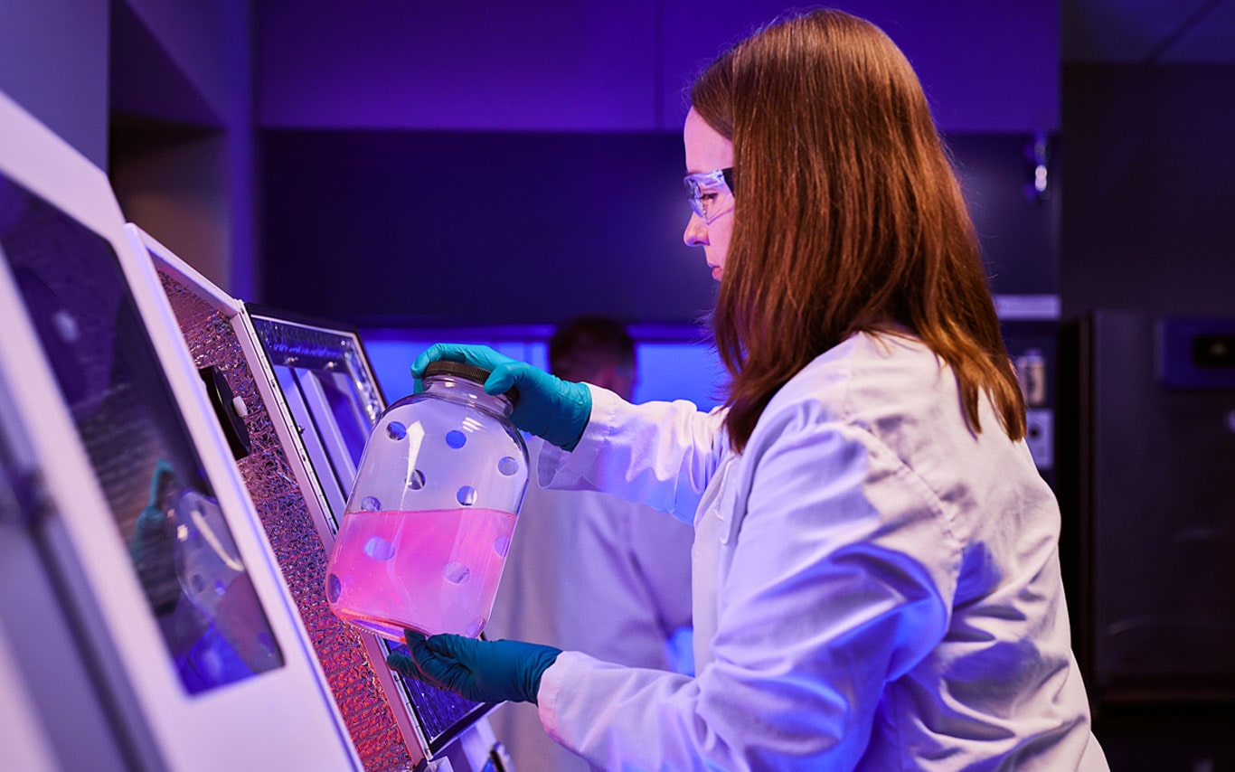 Scientist operating laboratory equipment, representing ACES Online programs.