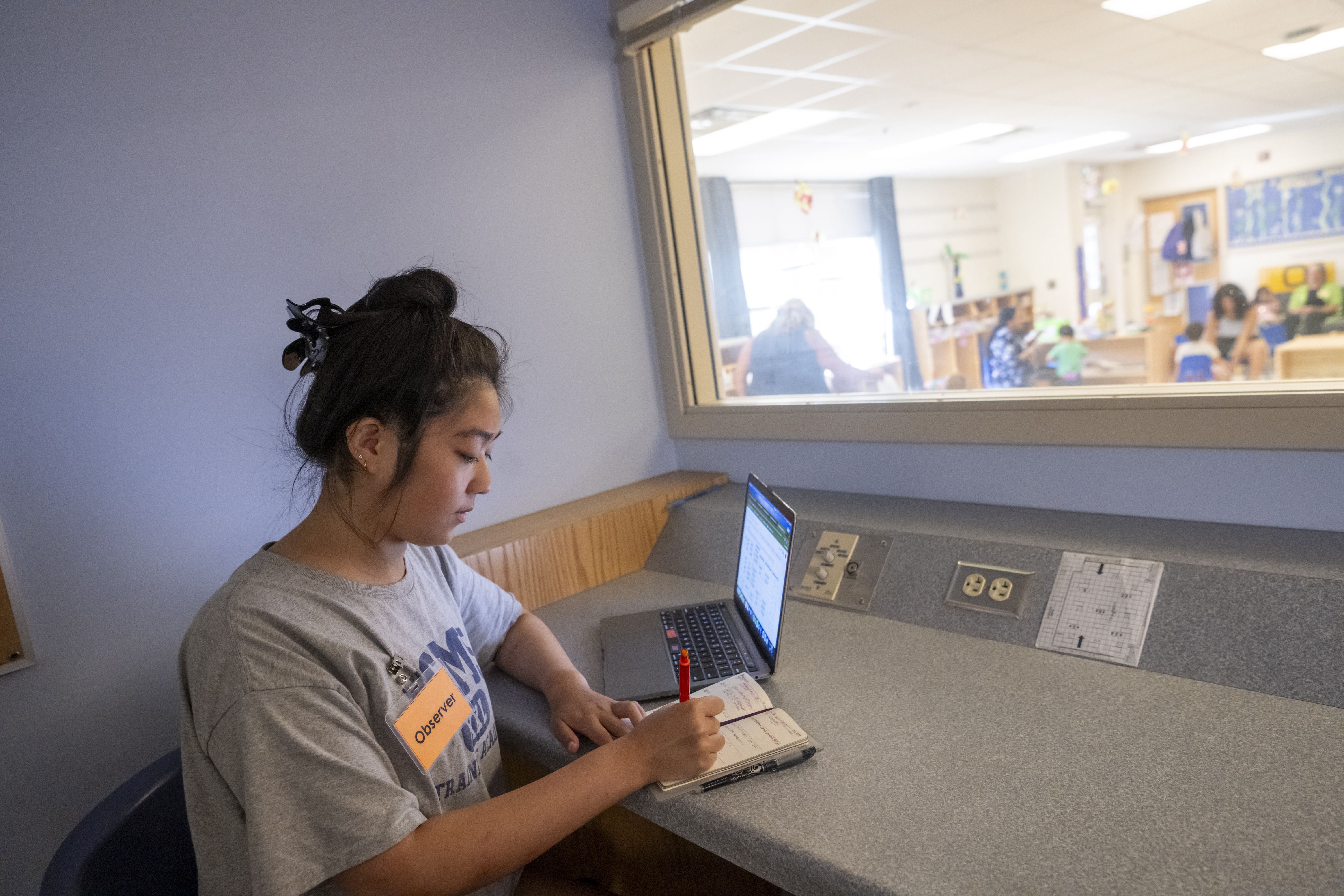 Student observing a toddler classroom