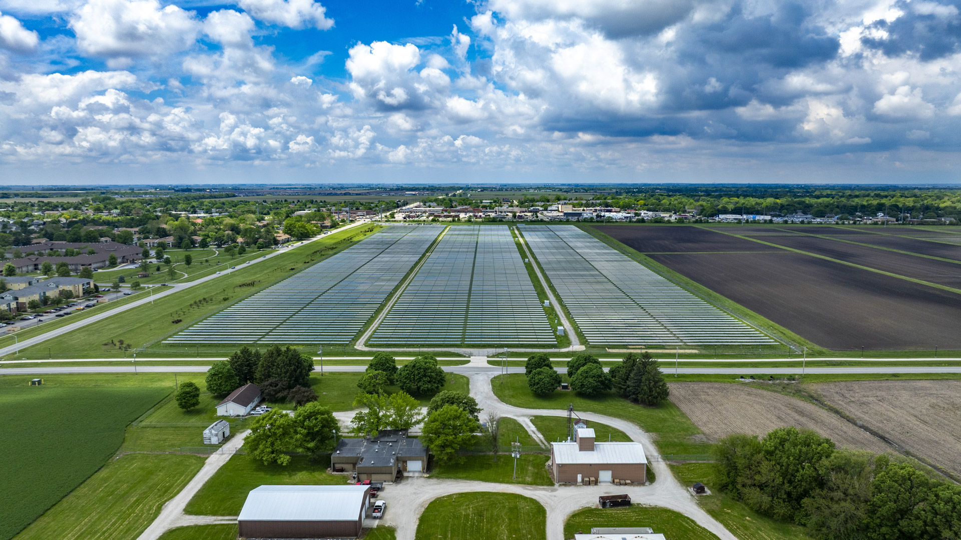 Aerial view of farmland and homestead real estate