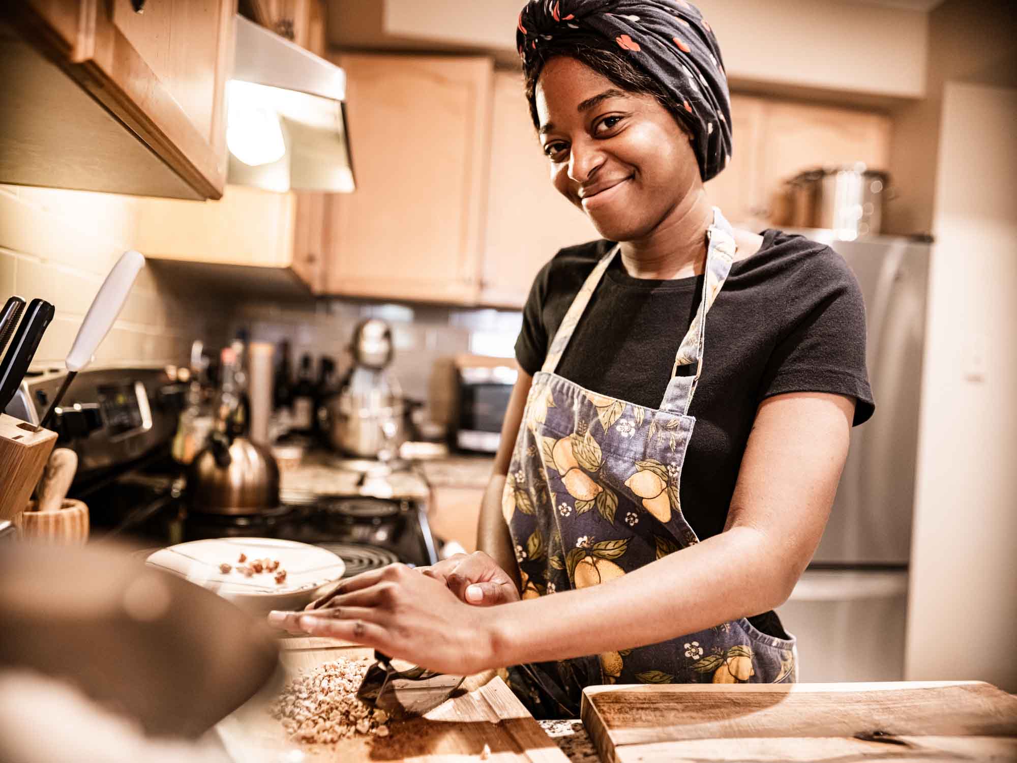 Person standing in kitchen preparing food
