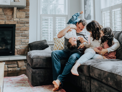 Parents and two children sitting on a couch